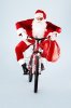 8225980-foto-di-babbo-natale-felice-con-rosso-sacca-in-bici.jpg